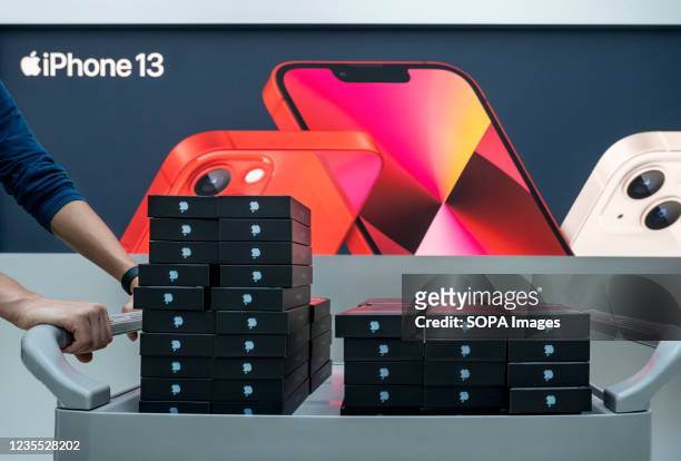 Apple workers carry stocks of iphone 13 smartphones to the store on the first weekend after the launch of the new iPhone 13 series smartphones in...
