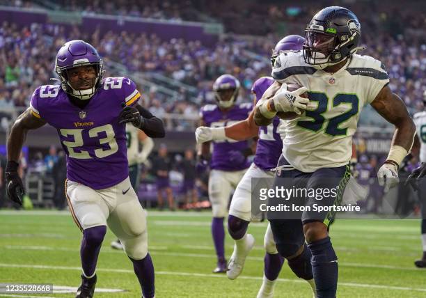 Seattle Seahawks Running Back Chris Carson scores a touchdown on this 30-yard run during the quarter second of a game between the Minnesota Vikings...