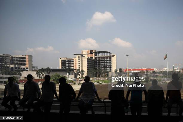 People wait outside Hazrat Shahjalal International airport in Dhaka, Bangladesh on September 26, 2021.