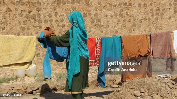 Woman hangs out the laundry in Golan Camp, where thousands of Waziristan refugee families have stationed, after they've been settled near the Durand...