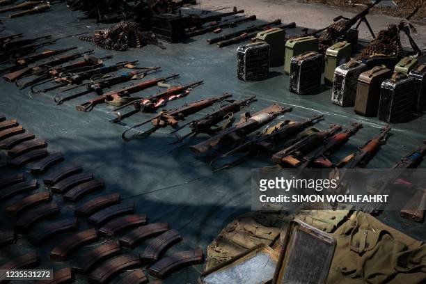 Weapons confiscated from the insurgents are displayed in Mocimboa da Praia, on September 22, 2021 by Rwandan soldiers. - Since July 2021 a contingent...