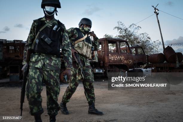 Mozambican soldiers patrol in front of a burned truck carrying the inscription "Shabaab Chinja" referring to the jihadist group in Mocimboa da Praia,...