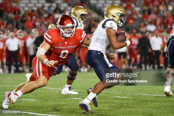 Houston Cougars defensive lineman Derek Parish chases down Navy Midshipmen quarterback Xavier Arline during the football game between the Navy...