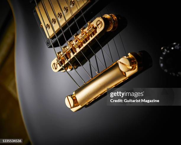 Detail of the LockTone tune-o-matic bridge and stud tailpiece on an Epiphone Joe Bonamassa Black Beauty Les Paul Custom electric guitar, taken on...