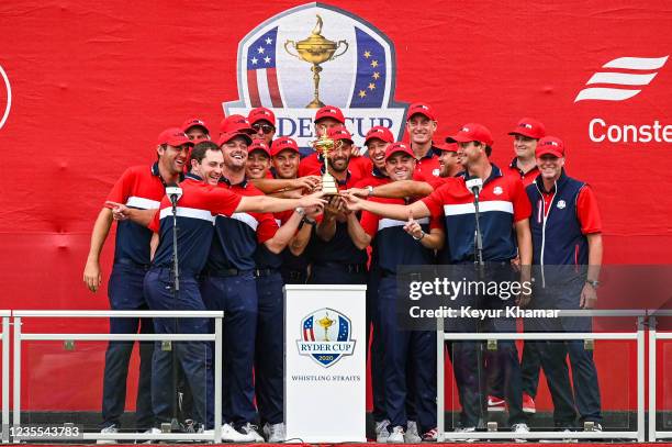 Members of the U.S. Team smile with the trophy following their 19-9 victory during Sunday Singles Matches of the 43rd Ryder Cup at Whistling Straits...
