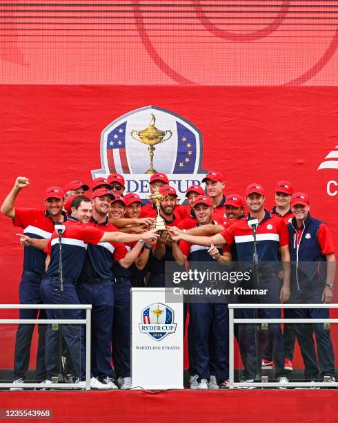 Members of the U.S. Team smile with the trophy following their 19-9 victory during Sunday Singles Matches of the 43rd Ryder Cup at Whistling Straits...