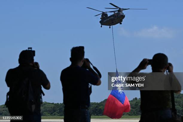Made CH-47 helicopter flies an 18-meter by 12-meter national flag at a military base in Taoyuan on September 28, 2021.