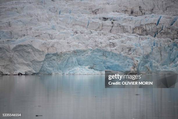 View of Nordenskiold glacier melting and collapsing in the ocean, near Pyramiden, in Svalbard, a northern Norwegian archipelago on September 21, 2021.