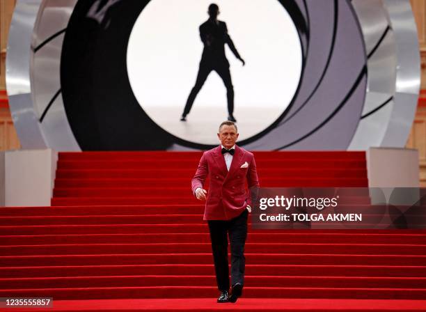 English actor Daniel Craig walks on the red carpet after arriving to attend the World Premiere of the James Bond 007 film "No Time to Die" at the...