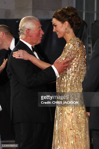 Britain's Prince Charles, Prince of Wales kisses Britain's Catherine, Duchess of Cambridge as they arrive for the World Premiere of the James Bond...