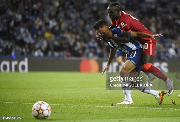 Liverpool's Senegalese forward Sadio Mane vies with FC Porto's Mexican forward Jesus Corona during the UEFA Champions League first round group B...