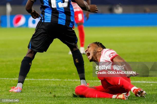 Leipzig's French midfielder Christopher Nkunku reacts after sustaining an injury during the UEFA Champions League Group A football match RB Leipzig v...