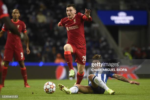 Liverpool's Scottish defender Andrew Robertson is tackled by FC Porto's Colombian midfielder Mateus Uribe during the UEFA Champions League first...
