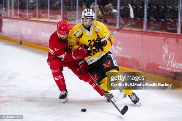 Simon Moser of SC Bern battles for the puck with Fabian Heldner of Lausanne HC during the Swiss National League game between Lausanne HC and SC Bern...