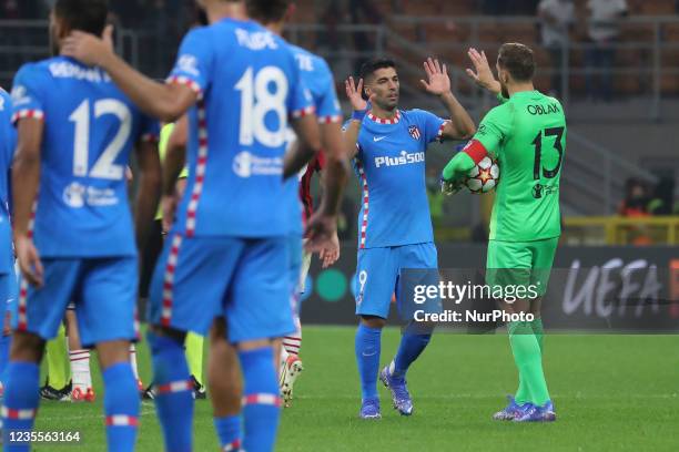 Luis Suarez of Atletico Madrid celebrates the win at end of the UEFA Champions League group B match between AC Milan and Atletico Madrid at Giuseppe...