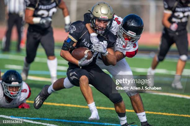 Rolling Hills Estates, CA Banning linebacker Anthony Jauregui, right, tackles Peninsula High wide receiverAaron Wakefield-Carl, after he lost his...