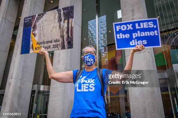 Participant seen holding signs at the protest.Rise and Resists Truth Tuesdays activists gathered in the public space in front of Fox Headquarters in...
