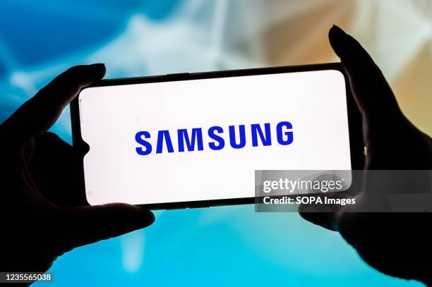 In this photo illustration, a Samsung logo seen displayed on a smartphone.