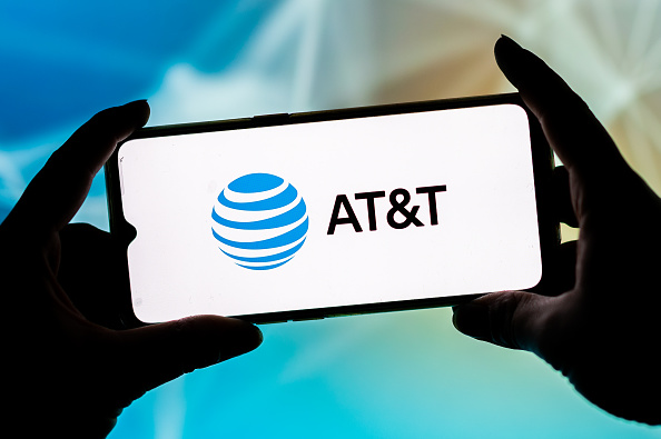 In this photo illustration, a AT&T logo seen displayed on a...