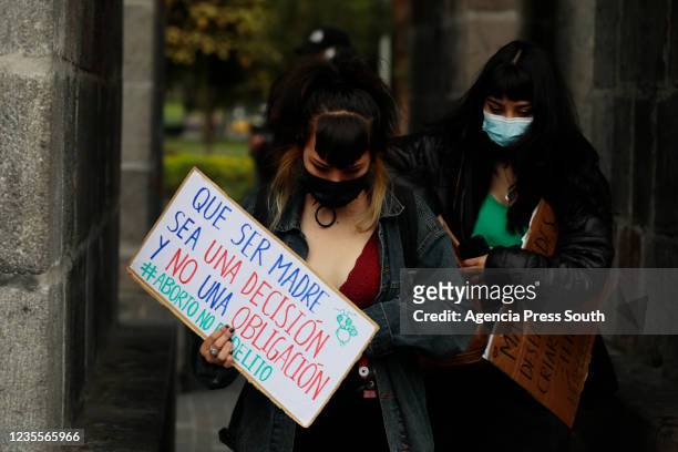 Woman walks with a sign during a Pro-Choice protest called 'Maternar, abortar, decidir y luchar en comunidad' on September 28, 2021 in Quito,...