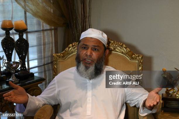 In this picture taken on September 24 former Pakistani cricketer Mushtaq Ahmed gestures as he speaks during an interview with AFP in Lahore. - Ahmed...