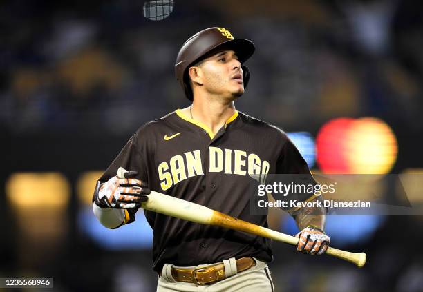 Manny Machado of the San Diego Padres walks to the dugout after grounding out against relief pitcher Blake Treinen of the Los Angeles Dodgers during...