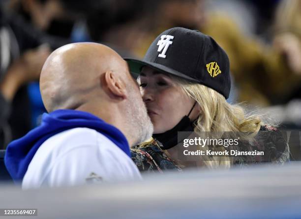 Chelsea Handler, wearing Kill The Hype baseball hat, and Jo Koy attend the game between the San Diego Padres and the Los Angeles Dodgers at Dodger...