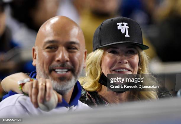 Chelsea Handler, wearing Kill The Hype baseball hat, and Jo Koy attend the game between the San Diego Padres and the Los Angeles Dodgers at Dodger...