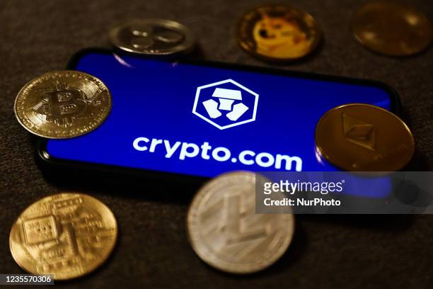 Crypto.com logo displayed on a phone screen and representation of cryptocurrencies are seen in this illustration photo taken in Krakow, Poland on...