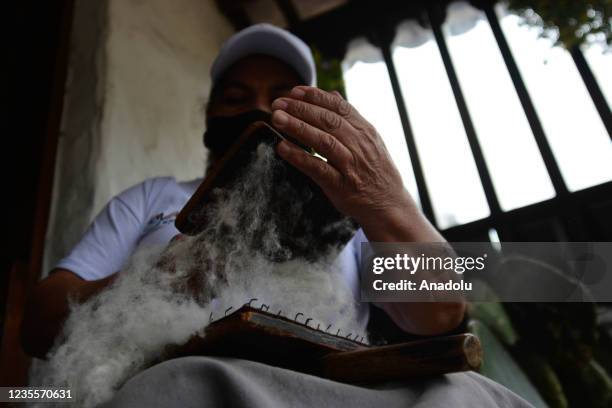 Maria Concepcion, a traditional weaver, processes the wool to make a yarn in Nobsa, located approximately 3 hours from Bogota in the department of...