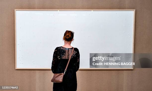 Woman stands in front of an empty frame hung up at the Kunsten Museum in Aalborg, Denmark, on September 28 2021. - The Danish museum loaned an artist...