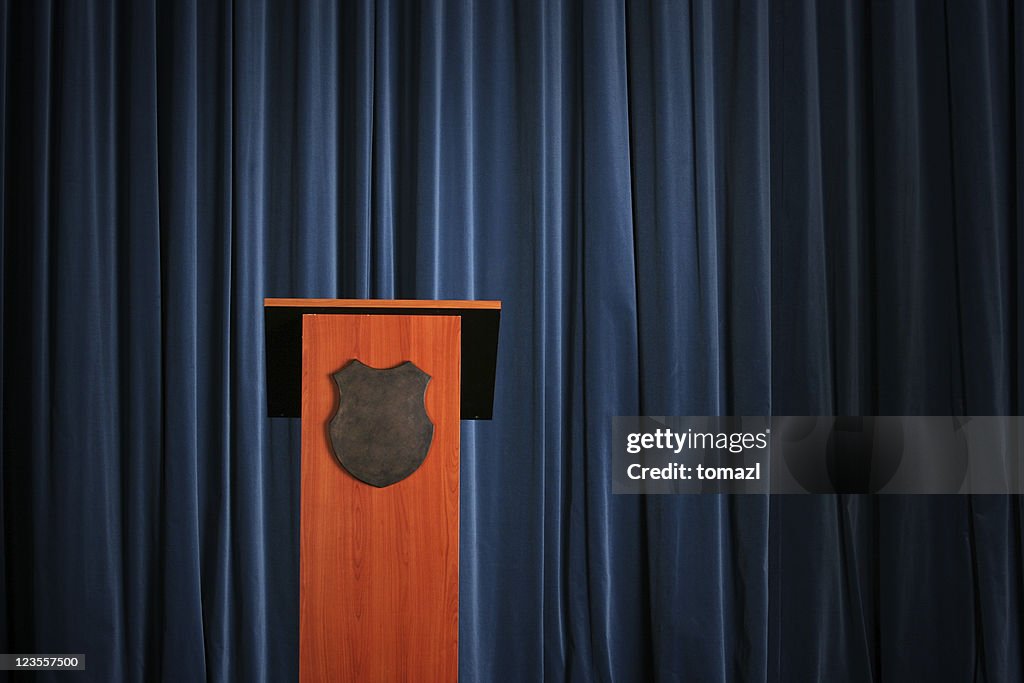 Empty press conference room with a wooden podium