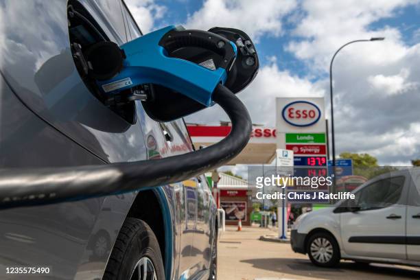 An electric car charges at a Motor Fuel Group station whilst petrol and diesel pumps are closed on the Esso forecourt due to the ongoing fuel crisis...