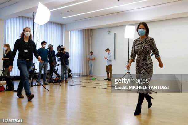 Co-leader of Germany's Greens and the party's candidate for chancellor Annalena Baerbock leaves after giving a statement following last night's...