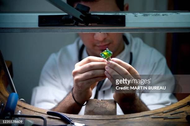 Jeweler works on a piece of the French Van Cleef & Arpels jewellery on January 14, 2010 in the workshop of the company in Paris.The company was...