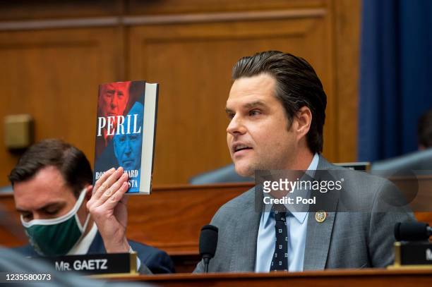 Rep. Matt Gaetz holds up a copy of the book Peril during a House Armed Services Committee hearing on Ending the U.S. Military Mission in Afghanistan...