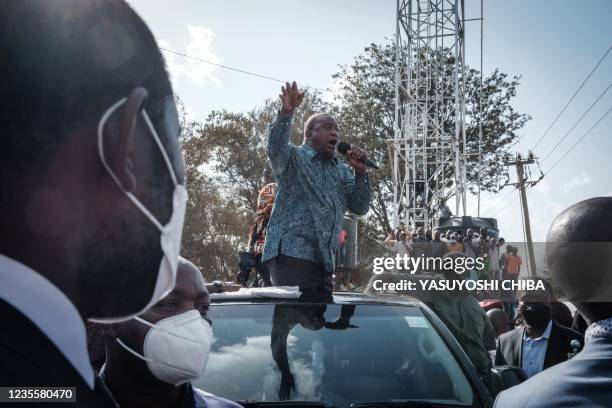 Kenya's President Uhuru Kenyatta speaks to people after attending an inauguration of Kibra Level 3 hospital in Kibera slum in Nairobi on September...