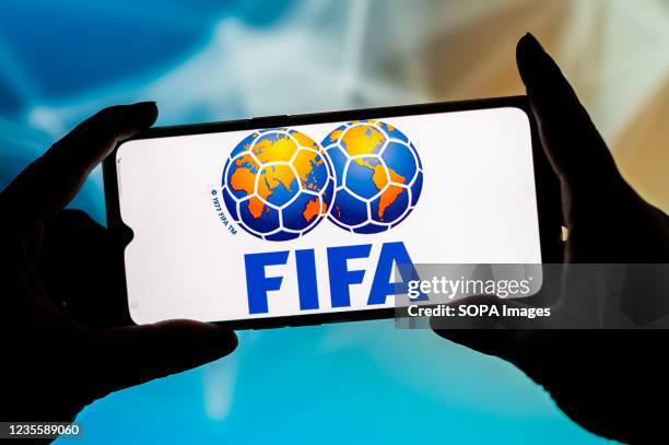 In this photo illustration, a FIFA logo seen displayed on a smartphone.