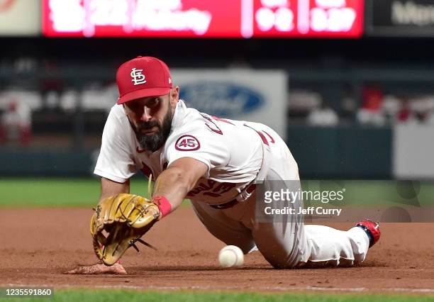 Matt Carpenter of the St. Louis Cardinals dives for a ground ball during the eighth inning against the Milwaukee Brewers at Busch Stadium on...