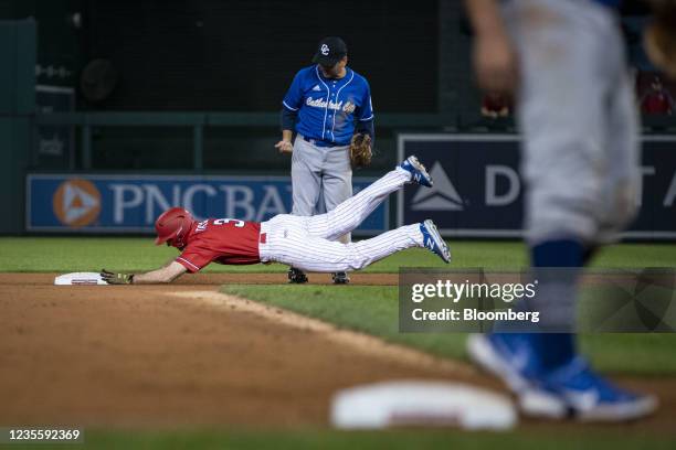 Representative Nicholas Van Taylor, a Republican from Texas, slides into second base as Representative Raul Ruiz, a Democrat from California, looks...