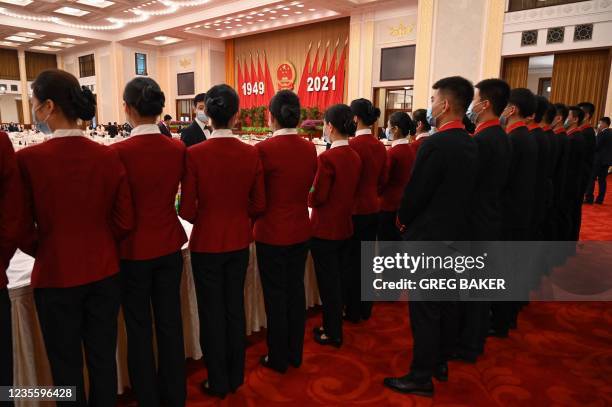 Attendants prepare before a reception at the Great Hall of the People on the eve of Chinas National Day in Beijing on September 30, 2021.