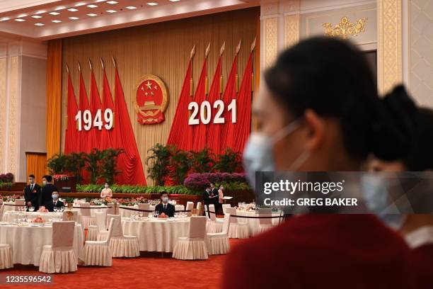 Attendants prepare before a reception at the Great Hall of the People on the eve of Chinas National Day in Beijing on September 30, 2021.