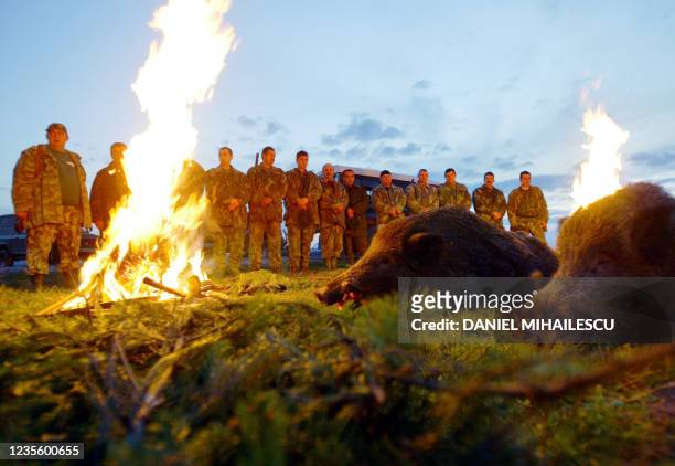 Local Romanian hunters and beaters pay respect to the game shot over the day-long hunting at the fire light near Oradea city, 600km North-West from...