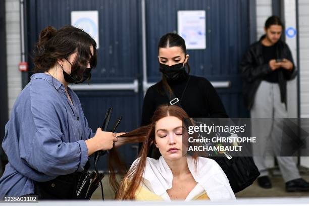 Model Gigi Hadid gets her hair done backstage ahead of the Coperni show during the Paris Fashion Week Spring Summer 2022 collection shows in Paris on...