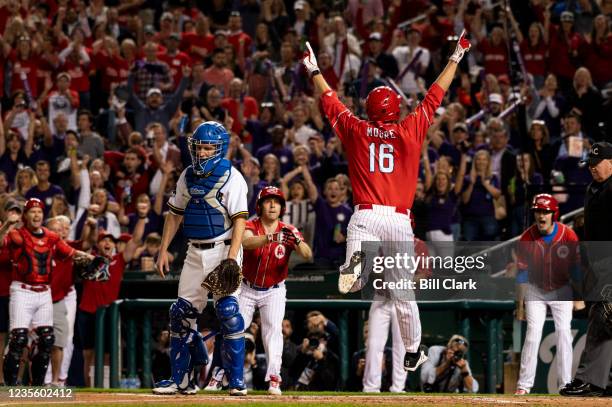 GOPs Rep. Blake Moore, R-Utah, celebrates his inside the park home run as Democrats catcher Sen. Chris Murphy, D-Conn., looks on during the...