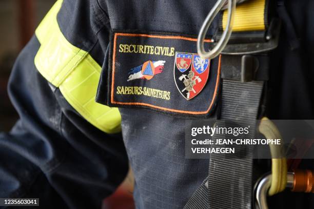 Badge "Civil security / Sapeur-rescuer" is pictured on the jacket of a firefighter during a rescue clearing training with the Moselle firefighters...