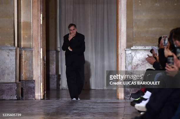 Belgian fashion designer Raf Simons acknowledges the audience at the end of his Womenswear Spring-Summer 2022 collection during the Paris Fashion...