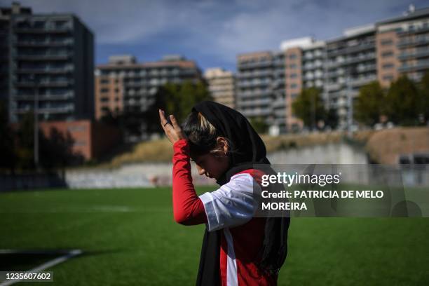 Player of Afghanistan national women football team arrives for a training session at Odivelas, outskirts of Lisbon on September 30, 2021. - Forced to...