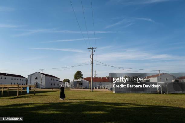 An Afghan refugee walks in the Village, where they are temporarily living at Ft. McCoy U.S. Army base on September 30, 2021 in Ft. McCoy, Wisconsin....