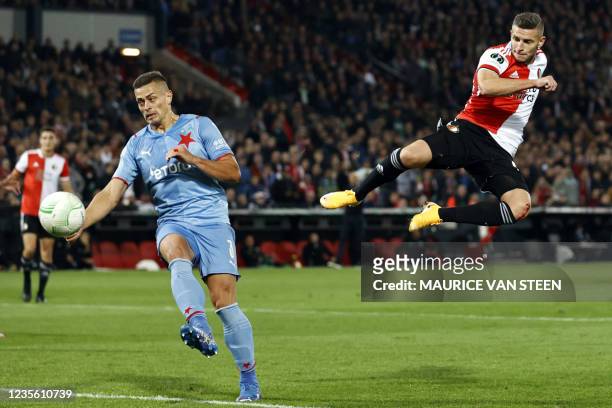 Slavia Prague's Czech defender Tomas Holes fights for the ball with Feyenoord's Dutch forward Bryan Linssen during the UEFA Conference League...